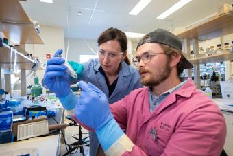 Jen Shafer and Klemmer Nicodemus inspect material in a nuclear engineering lab on the Mines campus