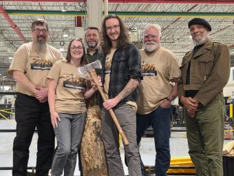 group shot of Mines students with their winning axe