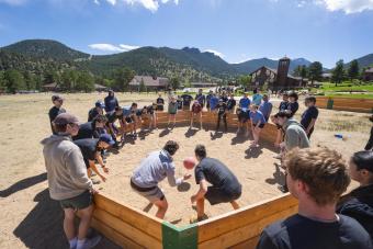 Students play Gaga Ball with mountains in the background