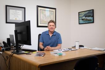 Tom Brady sitting at his desk