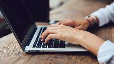 Stock image of woman typing on laptop