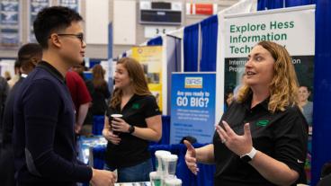 Benjamin Wang, a senior majoring in petroleum engineering, talks to a recruiter from Hess Corporation