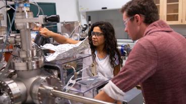 Physics Professor Meenakshi Singh in the lab with a student