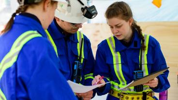 Fresh Air Base and Lead Technician Martina Gilbert, right, talks to Jaume Martinez Calvo and Sarah Vanhook about the competition problem.