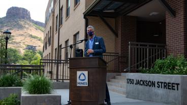 President Paul C Johnson speaks in front of 1750 Jackson