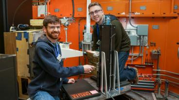 Colorado School of Mines graduate student researchers (left) Ben Schneiderman and Tim Pickle using neutrons at ORNL’s High Flux Isotope Reactor to measure residual stress in welds used to make renewable energy storage tanks. (credit: ORNL/Genevieve Martin)