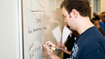 Student working at a whiteboard