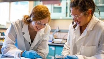 Two female students work in a lab