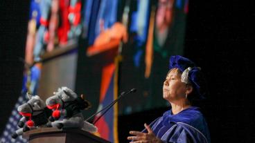 Stefanie Tompkins speaks from stage at commencemnt