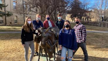 SME Design Competition team around Blaster statue