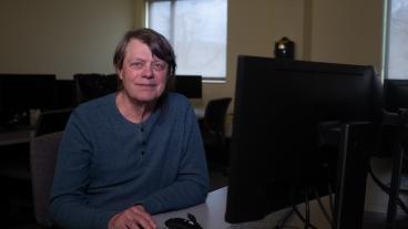 Mark Baldwin sitting at a computer