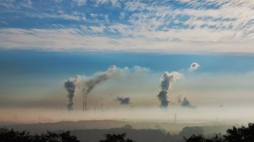 Smoke stacks against blue sky