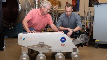 George Sowers with a lunar rover prototype