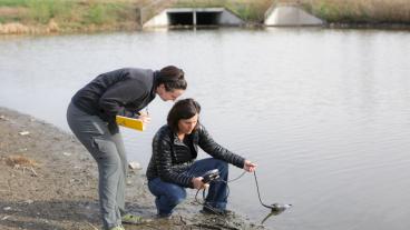 Terri Hogue and student take water reading