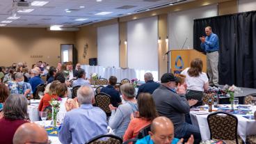 Provost Rick Holz claps at Faculty Awards Celebration