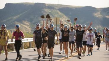 students carrying rocks during M Climb