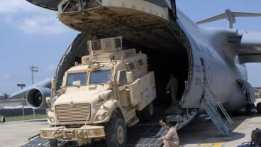 MRAP rolling off a plane