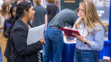 Mines student speaks to recruiter at Fall Career Day