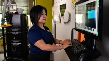 Professor Xiaoli Zhang works on a computer