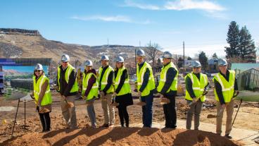 Mines officials scoop shovels of dirt at groundbreaking