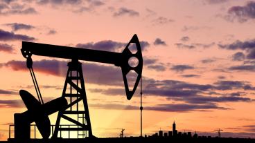 Stock image of oil pump at sunset