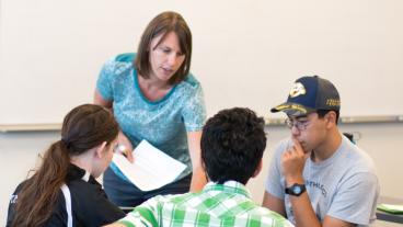 Becky Lafrancois interacts with students in economics class