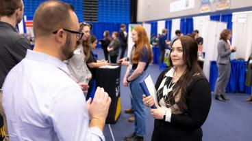 Alison Giachino, a senior studying chemical engineering, speaks to JR Hudnall '09 about job openings at Kiewit.