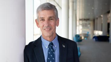 Paul Johnson standing in atrium of CoorsTek Center