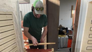 Chris Caskey loads tile into kiln