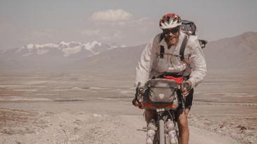 Peter Consalvi riding a bike in a desert