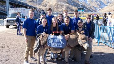 Blue Key students standing behind Blaster the Burro