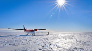plane parked on antarctic ice with bright sun (Surface over Mercer Subglacial Lake in Antarci (Photo by Philipp Arndt)
