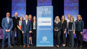 group shot of people holding an award on stage