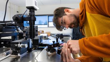male student works on photonic chip
