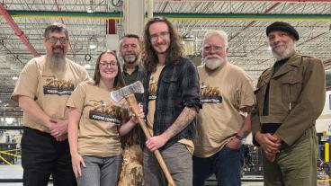 group shot of Mines students with their winning axe