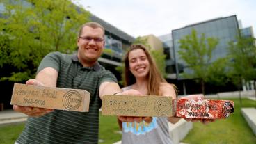 David Schmidt and Lindsey Hart holding bricks from Meyer Hall