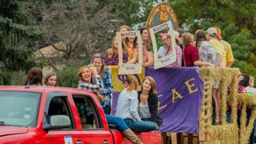 Mines students riding in a float for Homecoming 2015