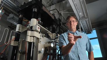 Ivar Reimanis holds a piece of glass