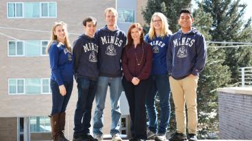 Megan Harris, Academic Advising Coordinator at CASA, stands in between her peer coaches.