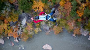 Chris Fehn BASE jumps above a river in West Virginia