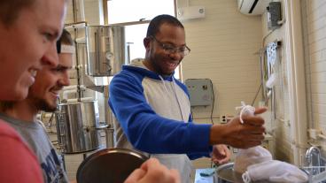 KC Agwu takes a turn at malting barley in the malting system. 