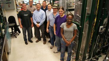 Colorado School of Mines – Delphi – Independent Energy Partners team next to the Geothermic Fuel Cell (far right) at the Colorado Fuel Cell Center: Dr. Bernard Fischer (Delphi), Prof. Neal Sullivan (CSM), Joe Bonadies (Delphi), Adam Wright (Delphi), Mark Wall (IEP), Buddy Haun (CSM), Mark Daubenspeck (CSM) and Gladys Anyenya (CSM). Not pictured: Prof. Robert Braun (CSM).