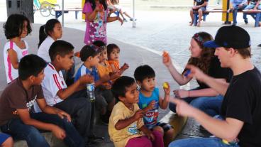 Mines students Krista Horn and Nate Thompson work with kids in the shanty towns of Lima. (Photo Credit: Nate Charboneau) 