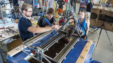 Justin Kilb, Michael Szostak and Caroline Ellis work on their water extraction system.