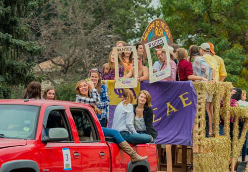 Mines students riding in a float for Homecoming 2015