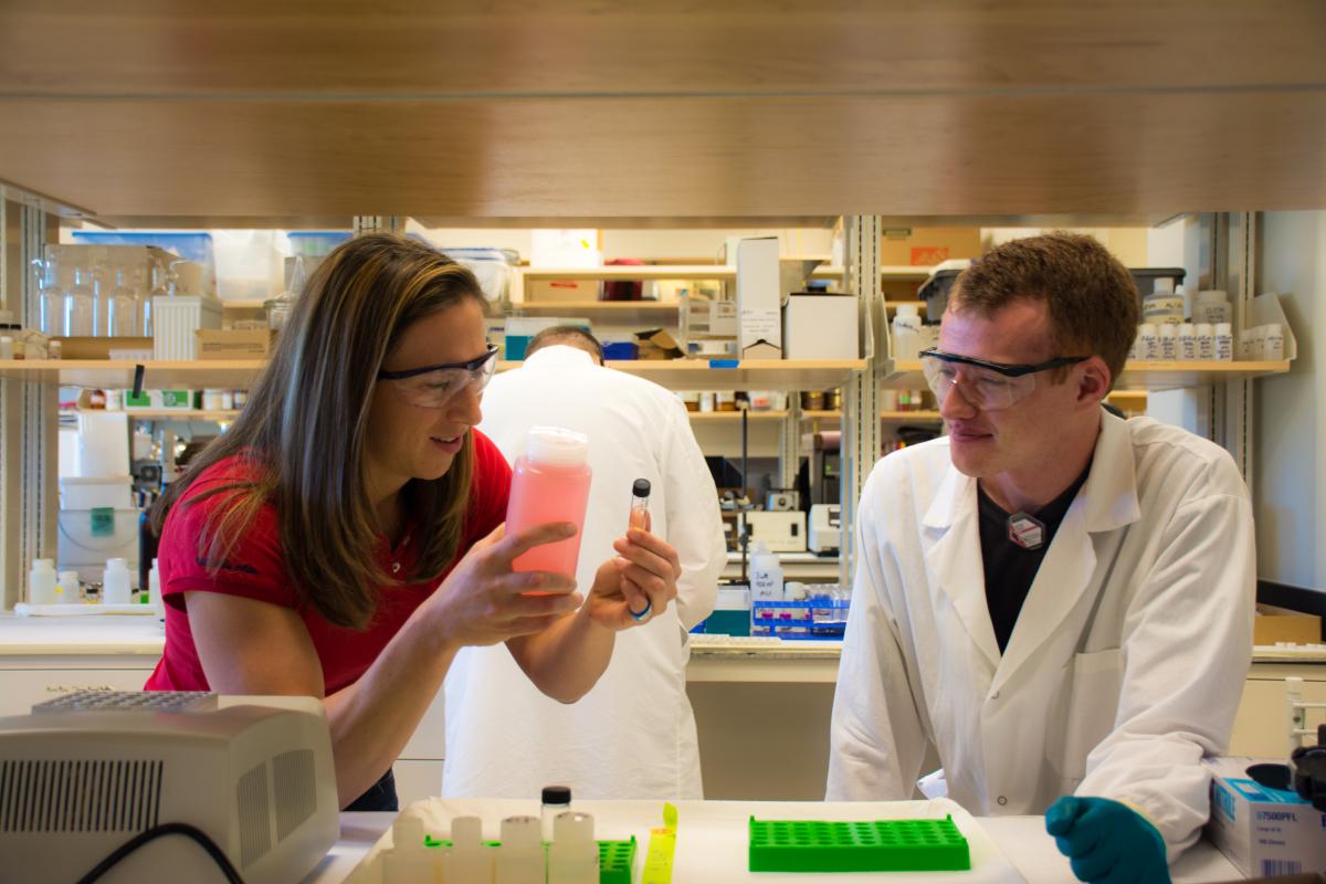 Student Nathan Bessen talks to Jenifer Braley in the radiochemistry lab