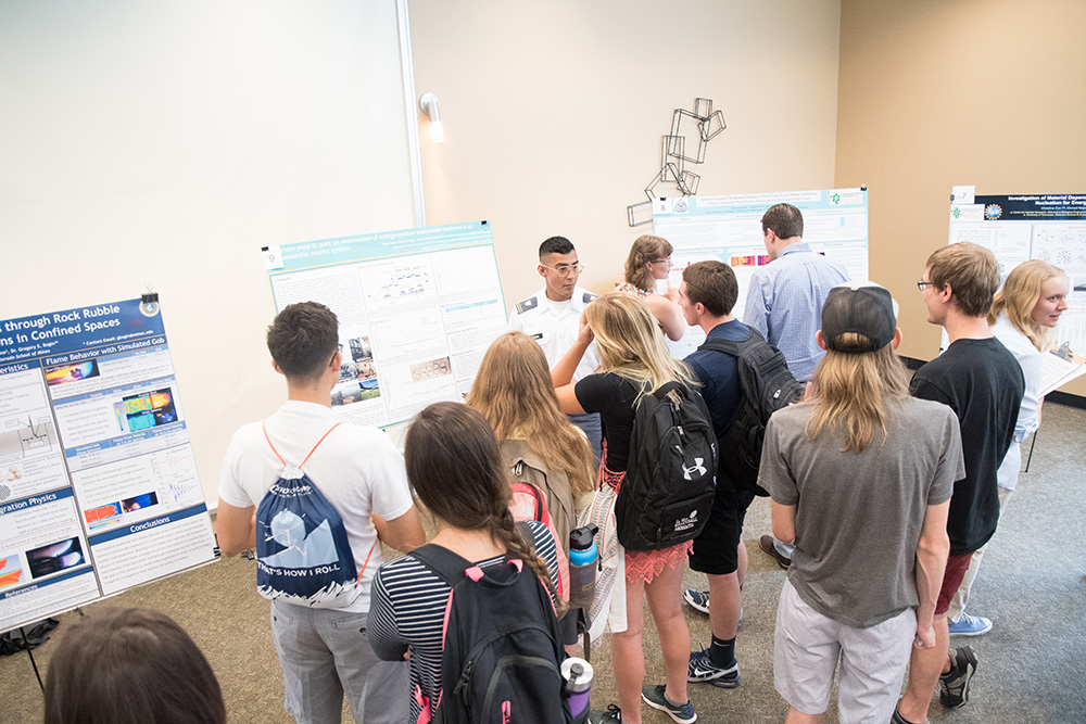 REU program participants share their research at the poster session.