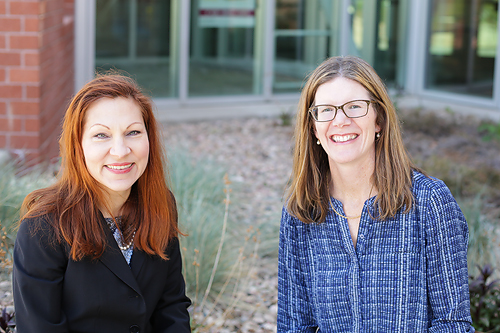 Two professors sit outside as they begin their time as Humanitarian Engineering Faculty Fellows.