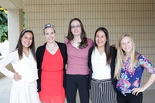 The five humanitarian engineering student scholars link arms for a photo.